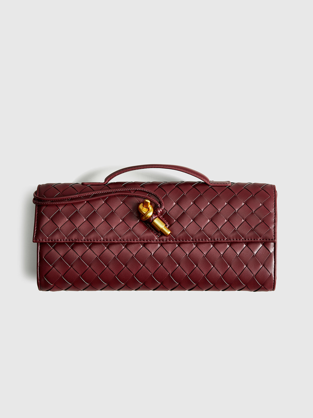 Bolso de mano tipo clutch con solapa tejida bidireccional